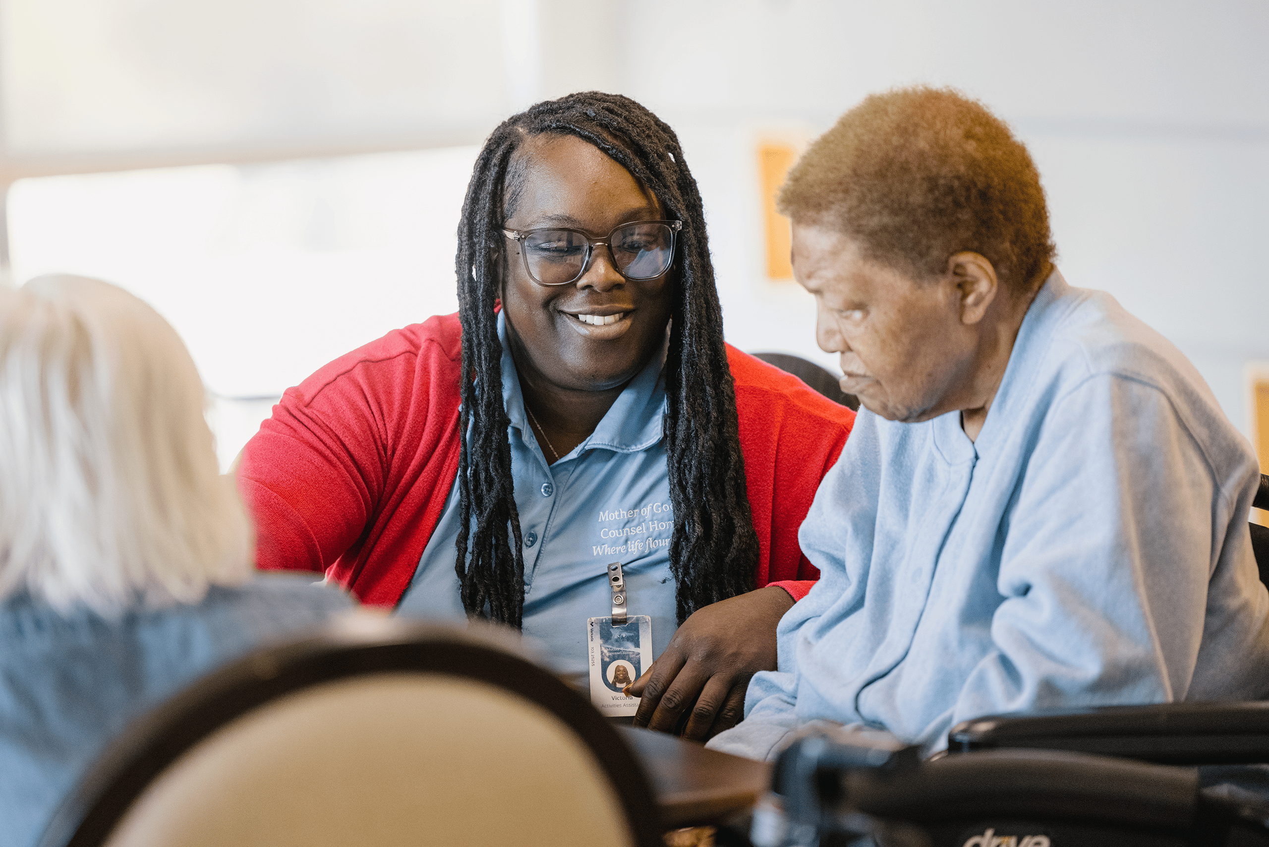 A Mission Partner sitting next to a resident
