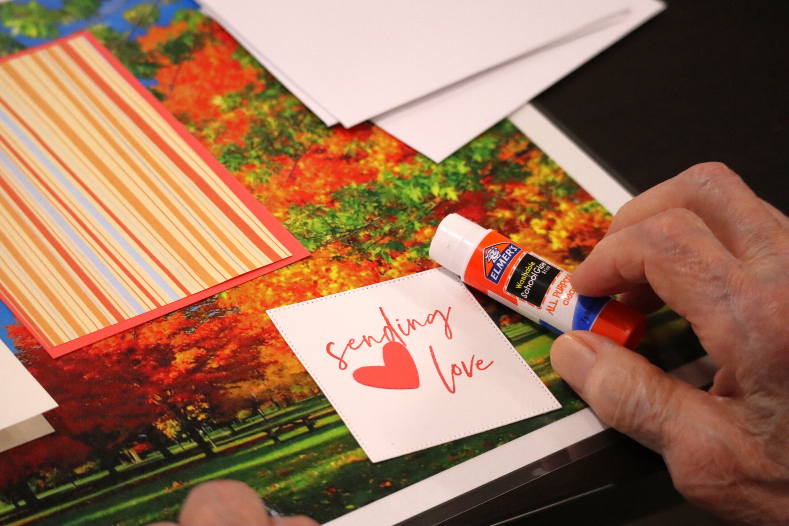 IMG_6029 a glue stick and piece of paper that says "sending love"