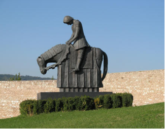 a statue of st francis on a horse